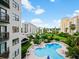 Enjoy views of the community pool, lush landscaping, and nearby buildings from your condo at 6165 Carrier Dr # 1603, Orlando, FL 32819