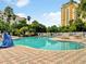 Enjoy a relaxing day at the outdoor pool area, with a deck, lounge chairs and manicured landscaping at 6165 Carrier Dr # 1603, Orlando, FL 32819