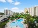 Enjoy the community pool surrounded by manicured landscaping and multiple resort buildings at 6165 Carrier Dr # 1603, Orlando, FL 32819