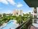 Balcony view overlooking the pool, palm trees, and complex in this tropical paradise at 6165 Carrier Dr # 1603, Orlando, FL 32819