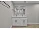 Modern bathroom with dual vanity and black framed mirrors at 68 Water Track Loop, Ocala, FL 34472