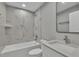 Elegant bathroom featuring marble-look tile, modern fixtures, and a vanity with a white countertop at 68 Water Track Loop, Ocala, FL 34472