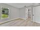 Bright bedroom boasts wood-look floors, fresh paint and natural light from the double hung window at 68 Water Track Loop, Ocala, FL 34472