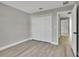 Bright bedroom featuring a large closet, light gray walls and wood floors at 68 Water Track Loop, Ocala, FL 34472