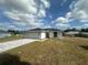 Beautiful single-story home showcasing a two-car garage and a lovely front lawn under a partly cloudy sky at 68 Water Track Loop, Ocala, FL 34472