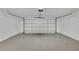 Spacious garage with white walls and epoxy flooring at 68 Water Track Loop, Ocala, FL 34472