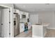 Contemporary kitchen featuring white cabinets, stainless steel appliances, an island, and stylish flooring at 68 Water Track Loop, Ocala, FL 34472