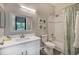 Bright bathroom with a white vanity, tile shower, and green botanical decor at 702 Gran Bahama Blvd, Davenport, FL 33897