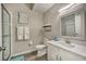 Clean bathroom with a white vanity, glass-enclosed shower, and decorative mirror at 702 Gran Bahama Blvd, Davenport, FL 33897
