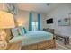 Comfortable bedroom with a wooden bed frame, side tables, blue accents, and a mounted television at 702 Gran Bahama Blvd, Davenport, FL 33897