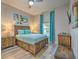 Comfortable bedroom with a wooden bed frame, side tables, and bright blue curtains at 702 Gran Bahama Blvd, Davenport, FL 33897