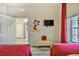 Fun bedroom with two twin beds, a Mickey Mouse decal, and red curtains at 702 Gran Bahama Blvd, Davenport, FL 33897