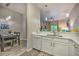 Stylish kitchen and dining area with modern countertops, dishwasher and seamless flow to the living room at 702 Gran Bahama Blvd, Davenport, FL 33897