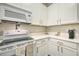 Close up of modern kitchen with white cabinets, range, and stainless steel microwave at 702 Gran Bahama Blvd, Davenport, FL 33897