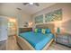 Comfortable main bedroom featuring beach themed art, a wicker headboard, and turquoise bedding at 702 Gran Bahama Blvd, Davenport, FL 33897