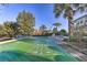 Community shuffleboard court offers fun activities amidst lush landscaping and sunny skies at 702 Gran Bahama Blvd, Davenport, FL 33897