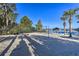 A sandy beach volleyball court under a blue sky with shade and lake views at 702 Gran Bahama Blvd, Davenport, FL 33897