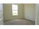 Bright, neutral-toned bedroom with ample natural light from the window, ready for personalization at 7562 Sunflower Cir, Kissimmee, FL 34747