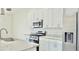Well-lit kitchen showcasing stainless steel appliances, granite countertops, and ample white cabinetry at 7562 Sunflower Cir, Kissimmee, FL 34747