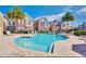 Community pool with lounge chairs, palm trees, and well-manicured landscaping at 7562 Sunflower Cir, Kissimmee, FL 34747