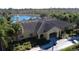 Aerial view of clubhouse showing a lake, pool, fountain, trees, and well maintained landscaping at 7564 Sunflower Cir, Kissimmee, FL 34747