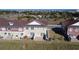 Rear exterior view of a two-story townhome featuring a private outdoor patio at 7564 Sunflower Cir, Kissimmee, FL 34747