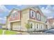 Well-maintained townhouse with tan and red siding, white trim, parking and green space at 7564 Sunflower Cir, Kissimmee, FL 34747