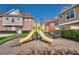Bright and colorful community playground with slides and climbing structures in a safe, wood-chipped area at 7564 Sunflower Cir, Kissimmee, FL 34747