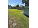 Large grassy backyard with wooden privacy fence, and lush green grass at 804 Carrousel Ln, Kissimmee, FL 34759