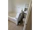 A well-lit bathroom with a tiled floor, bathtub, toilet, and storage cabinet at 804 Carrousel Ln, Kissimmee, FL 34759