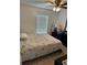 Neutral bedroom featuring tile floors, floral patterned bedding, and a ceiling fan at 804 Carrousel Ln, Kissimmee, FL 34759