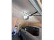 A residential garage with a vehicle, hot water tank, garage door opener, and brick walls at 804 Carrousel Ln, Kissimmee, FL 34759