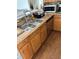 Well-lit kitchen sink area with oak cabinets, mosaic backsplash, and stainless steel appliances at 804 Carrousel Ln, Kissimmee, FL 34759