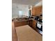 View of the kitchen with oak cabinets, stainless appliances, and an island overlooking living room at 804 Carrousel Ln, Kissimmee, FL 34759