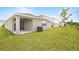 Home exterior featuring a grassy lawn and a concrete patio at 804 Lake Dell Rd, Dundee, FL 33838