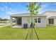 Home exterior featuring a grassy lawn and a concrete patio at 804 Lake Dell Rd, Dundee, FL 33838