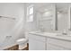 Bright bathroom featuring a double vanity with white cabinetry and wood-look tile floor at 804 Lake Dell Rd, Dundee, FL 33838