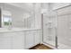Bright bathroom featuring a double vanity with white cabinetry and a glass-enclosed shower at 804 Lake Dell Rd, Dundee, FL 33838