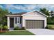 Charming single-story home featuring a two-car garage, covered entry, and well-maintained landscaping at 804 Lake Dell Rd, Dundee, FL 33838