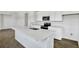 Modern kitchen with quartz countertop island and stainless-steel faucet at 804 Lake Dell Rd, Dundee, FL 33838