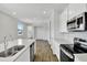 Open-concept kitchen featuring stainless appliances, island, and backyard view at 804 Lake Dell Rd, Dundee, FL 33838