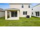Exterior view of the home showcasing the back patio and manicured lawn at 808 Lake Dell Rd, Dundee, FL 33838