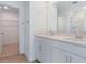 Modern bathroom featuring dual sinks, quartz countertop, and walk-in shower with glass door at 808 Lake Dell Rd, Dundee, FL 33838