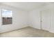 This bedroom has a neutral carpet, a door and a window at 808 Lake Dell Rd, Dundee, FL 33838