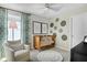 Charming Bedroom with a wooden crib, cozy armchair, and whimsical wall decor at 808 Lake Dell Rd, Dundee, FL 33838