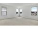 Bright bedroom with neutral carpet, white walls and multiple windows bringing in lots of natural light at 808 Lake Dell Rd, Dundee, FL 33838