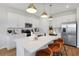 Bright kitchen featuring a large island with seating, stainless steel appliances, and stylish pendant lighting at 808 Lake Dell Rd, Dundee, FL 33838