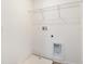 Empty laundry room featuring tile floors, plumbing fixtures and wire shelf at 808 Lake Dell Rd, Dundee, FL 33838