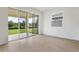 Living Room featuring sliding glass doors that lead to a large backyard at 808 Lake Dell Rd, Dundee, FL 33838