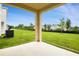Covered patio with view of expansive grassy backyard at 808 Lake Dell Rd, Dundee, FL 33838
